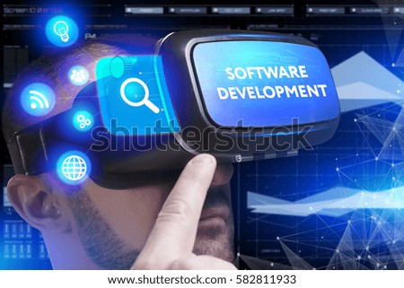 Business, Technology, Internet and network concept. Young businessman working in virtual reality glasses sees the inscription: Software development