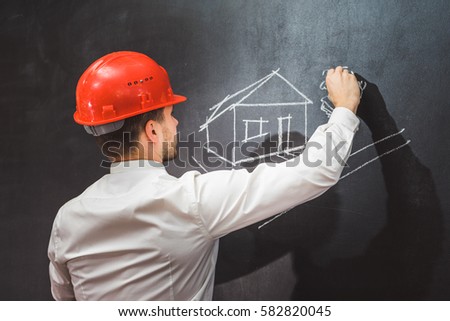 Man in suit pointing something,writing on chalkboard,back view,isolated.Copyspace blank,back view,house picture