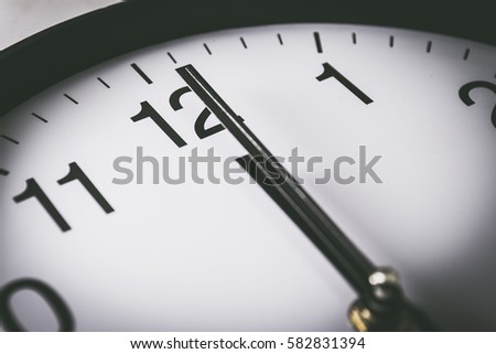 Close up of clock with selective focus at 12 Oclock Royalty-Free Stock Photo #582831394