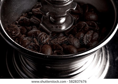 Vintage manual coffee grinder with coffee beans isolated.