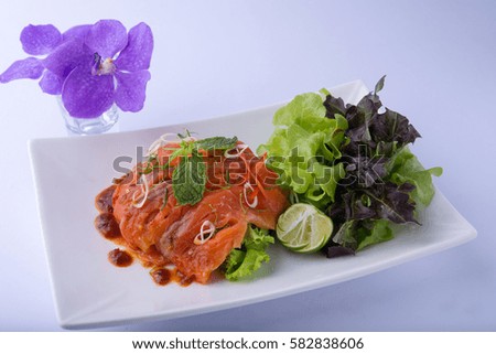 Salmon salad with lemon grass and mint on white dish , white background