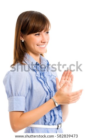 Portrait of young happy clapping businesswoman, isolated on white background. Caucasian female model in business success concept studio shot.