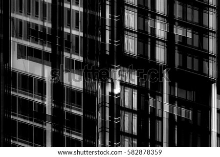 Multistory office building / high-rise / skyscraper midsection. Grunge abstract black and white photo of contemporary architecture.