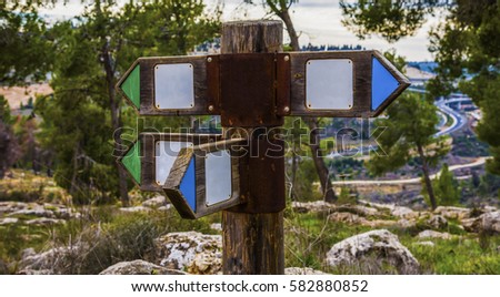 Wooden direction sign with two arrows in opposite directions on white background wooden arrow on the road in different