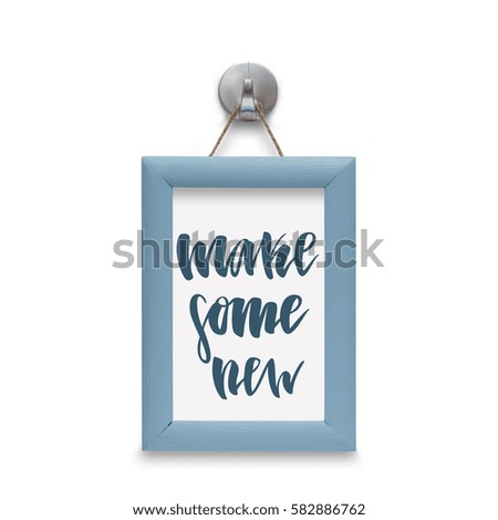 Make some new - motivational quote. Stylized lettering. Blue wooden frame. Isolated on white