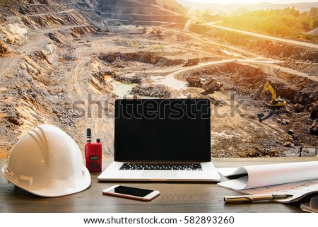Engineering Industry concept, workspace of engineer on opencast mining quarry with lots of machinery at work This area has been mined for copper, silver, gold, and other minerals background Royalty-Free Stock Photo #582893260