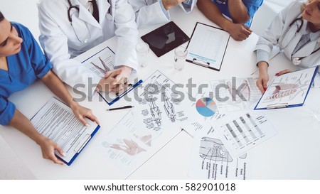 Cropped image of successful medical doctors discussing diagnosis during the conference Royalty-Free Stock Photo #582901018