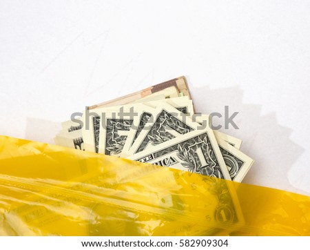 US dollars in a yellow plastic bag. Money exchange. Change for US currency.
