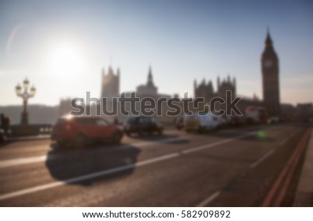 blurred background of traffic on Westminster Bridge with typical English cabs and buses