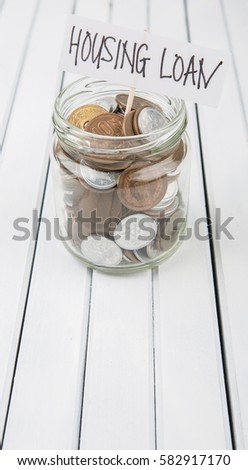 Conceptual image of housing loan with Japanese coins in mason jar over wooden background