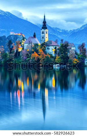 Fantastic view of night scenery at Bled lake with church on island . Dramatic , picturesque fall scene. Popular tourist attraction. Bled town, Slovenia, Europe. Artistic picture. Blue toning.
