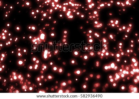 Red  abstract festive background, glitter or bokeh lights. Round defocused particles. isolated on black
