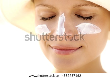 Suntan Lotion Woman Applying Sunscreen Solar Cream. Royalty-Free Stock Photo #582937162