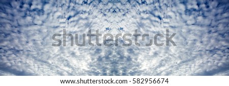 Wide sky panorama with fancy curly clouds highlighted by the sun. Heavenly background in a highly patterned top. Free space atmospheric flight and freedom. 