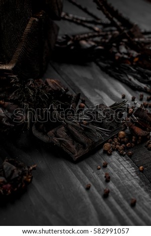wood composition of the pieces of wood and branches on a black wooden background