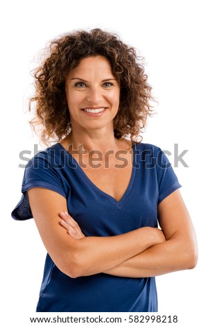 Smiling middle aged woman with arms folded, isolated on white background