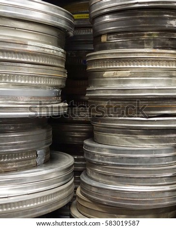 pile of antique old fashion metallic movie cans used in the cinema for protecting the picture roll
