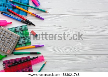 stationery. notebooks, pens, calculator on white wooden background Royalty-Free Stock Photo #583021768
