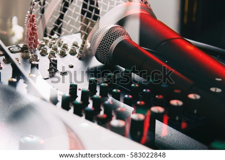 Amateur recording studio audio equipment.Vocal microphone and sound mixer technology.Abstract double exposure film toning