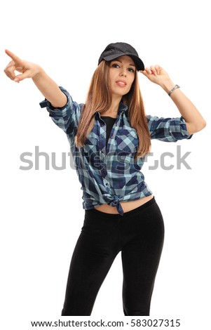 Young woman with a baseball cap pointing with her hand isolated on white background