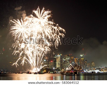 Fireworks over Sydney Harbor with the Sydney Opera House lit up on New Years Eve in Australia. 