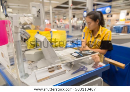 blur picture background; of customer queue for pay money at shopping counter; cashier with customer assistant in furniture mall