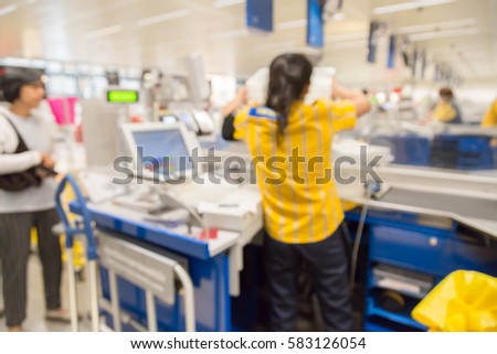 blur picture background  of customer queue for pay money at shopping counter  cashier  customer assistant in furniture mall 
