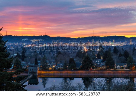 Colorful sunset over Mt Tabor City Park Reservior and the skyline of Portland Oregon downtown