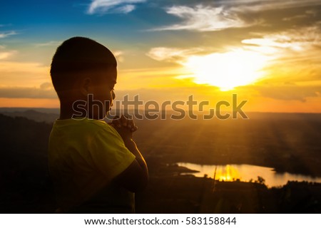 Boy praying on the Mount, thank God. Royalty-Free Stock Photo #583158844