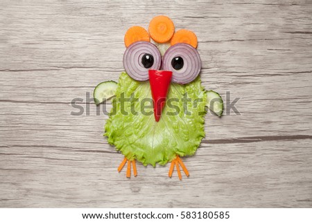 Amusing chicken made of vegetables on table