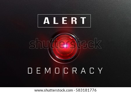 Red glowing warning lamp or button black panel with the words, "DEMOCRACY"and "Alert"