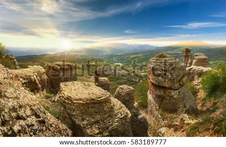 Summer landscape of the southern Crimea, overlooking the Black Sea and the surrounding mountains, in the bottom of Alushta. In the foreground weathered pillars called Valley of ghosts, Rossia.