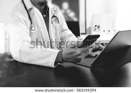 Medical technology concept. Doctor working with smart phone and stethoscope and digital tablet computer in modern office at hospital,black and white