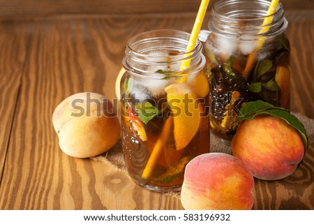 Homemade lemonade of ripe peaches and cold fresh mint. A jar of peach tea. Refreshing water.