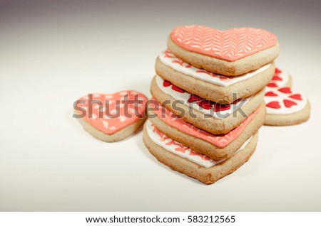 Heart shaped cookies with icing on a light background. Retro toning