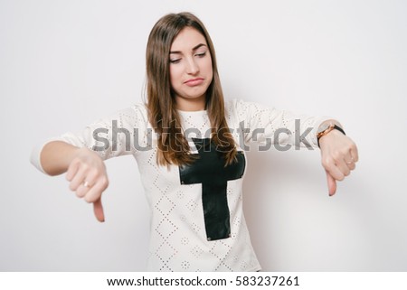 Woman showing a thumb down gesture