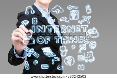 Young Smart business woman writing internet of things idea concept. Elegant Design for technology in the future for wireless communication network infrastructure of the information society.