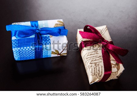 Gifts basket and candle against black background
