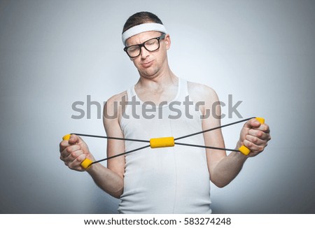 Nerd exercise with expander doing fitness - training, isolated on gray white background