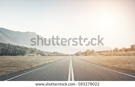 Natural summer landscape with asphalt road to horizon Royalty-Free Stock Photo #583278022