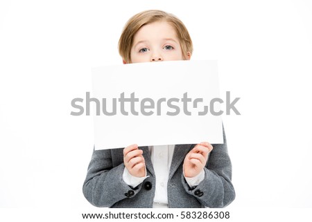 Little boy hiding his face behing blank card isolated on white