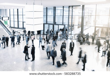 unrecognizable business people rushing in a modern trade fair hall