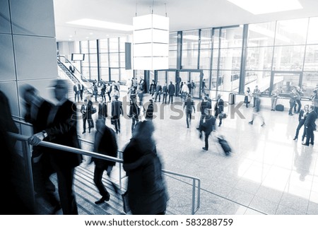 Blurred business people at a modern trade fair mall