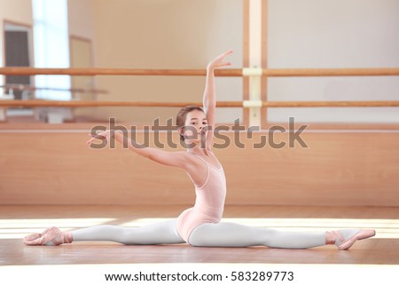 Little ballerina training in dance hall