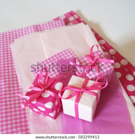 Gift boxes for the holiday. White background. Paper tissue pink. 