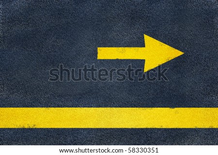 Asphalt road yellow marking. Direction arrow Royalty-Free Stock Photo #58330351