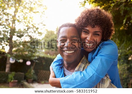 Portrait Of Loving Mature Couple In Back Yard Garden
