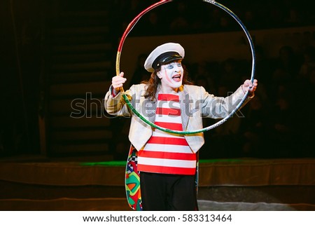 Funny clown performs at the circus.