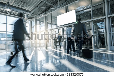 Blurred business people walking at a entrance 