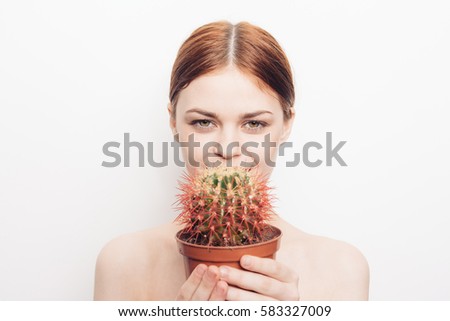 Woman with red red cactus in hands
